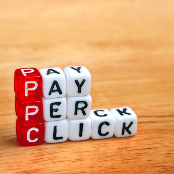 Pay Per Click dice on a wooden background.