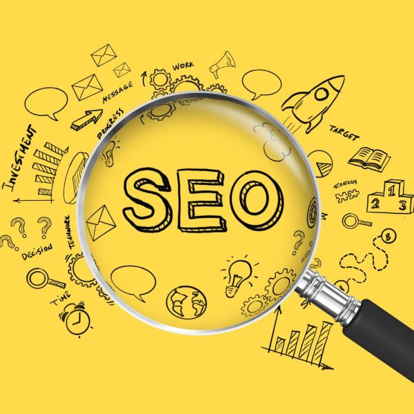 A word SEO under magnifying glass on a yellow background.